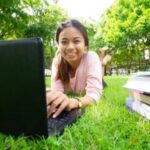 summer school - student with laptop in a park