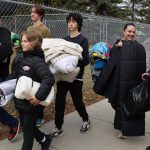 Grade 8 student leaders helping take donated blankets to St. Mary's Parish Outreach Centre
